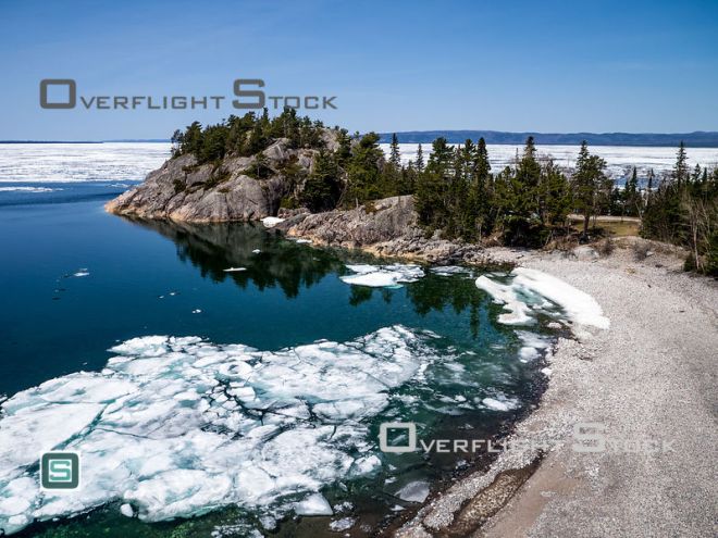 Stock aerial photo. It is early May and there is still ice covering sheltered portions of Lake Superior. This is near the mouth of the Montreal River. Click To View Location
